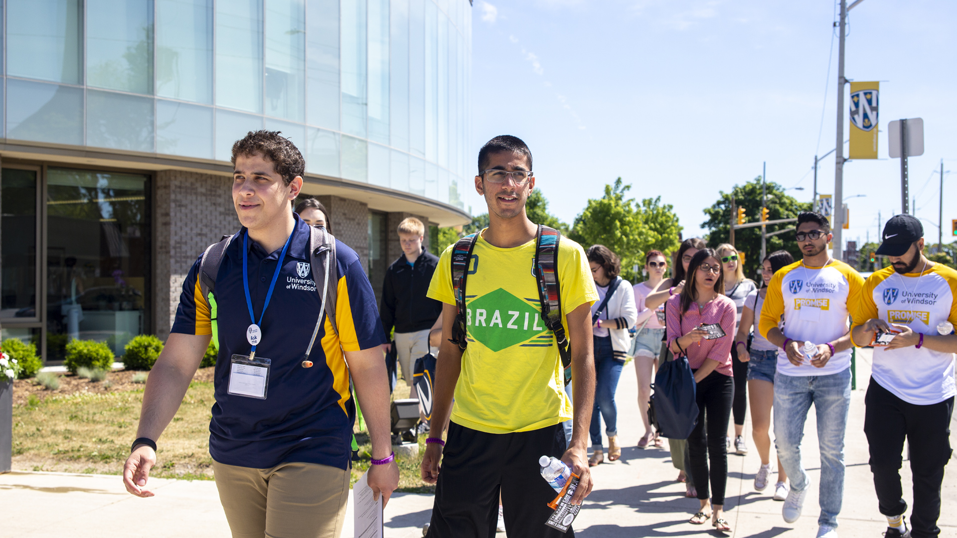 man with brazil shirt on walking on campus during welcome week